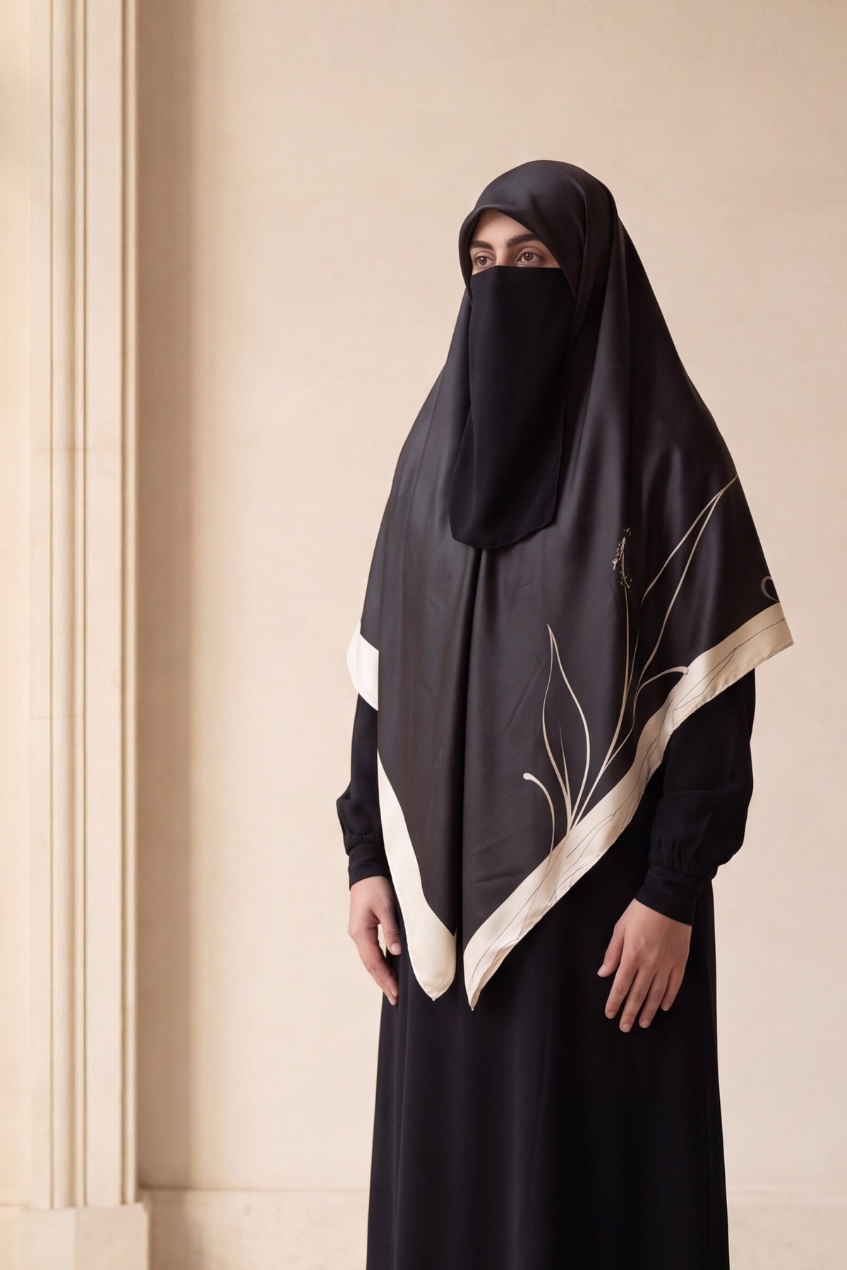 AmenaHijab campaign – Tharaa Beige silk hijab in an ivory arcade