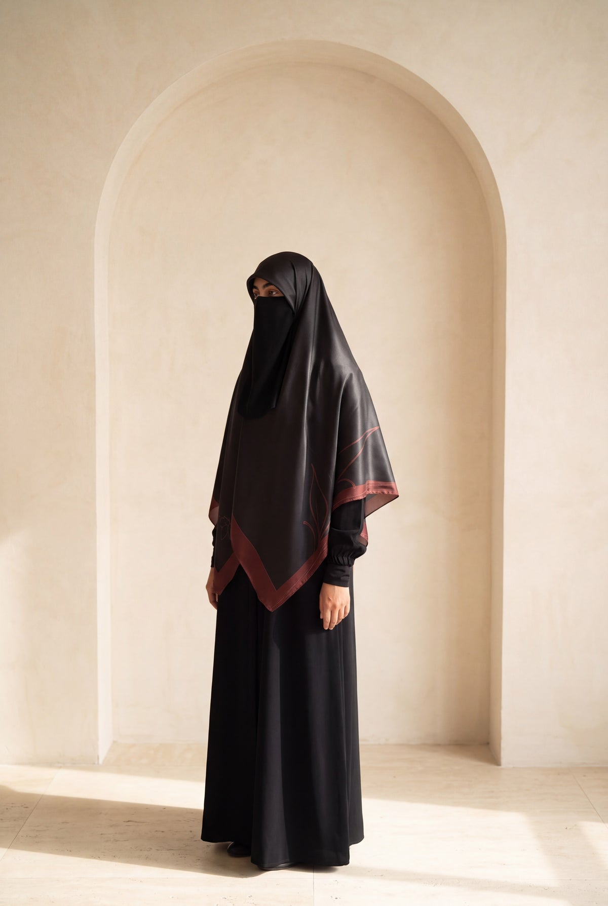 Luxury Turkish Silk Hijab – Tharaa Maroon, worn in an ivory studio